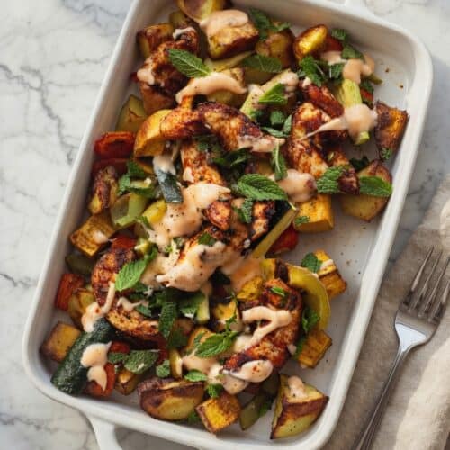 Overhead bowl of low FODMAP chicken recipes traybake with roasted vegetables, IBS safe and Monash-verified