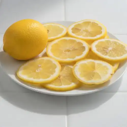 Low FODMAP lemon herb vinaigrette recipe in a glass jar with fresh chives, is lemon low fodmap