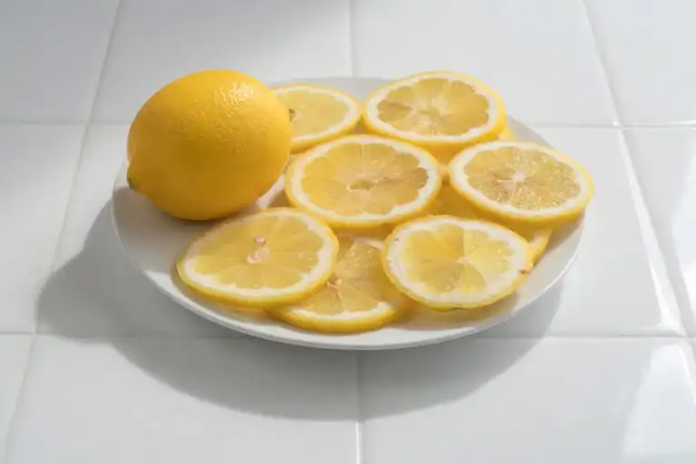 Low FODMAP lemon herb vinaigrette recipe in a glass jar with fresh chives, is lemon low fodmap