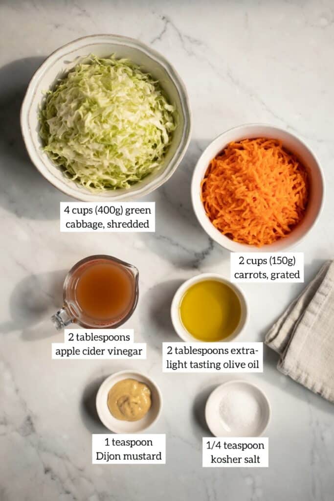 Ingredients for a low fodmap salad dressing including olive oil, apple cider vinegar, and Dijon mustard