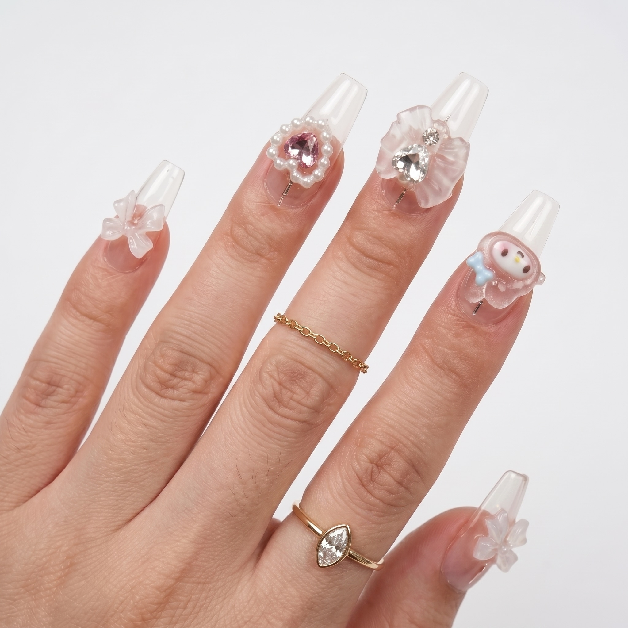Pink gradient acrylic press-ons with glossy tips and a soft almond shape on one hand.