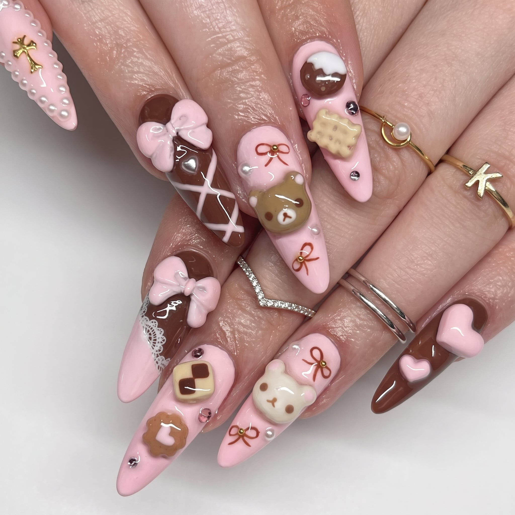 White French acrylic press-ons with a glossy nude base and long almond tips styled with an olive sleeve.