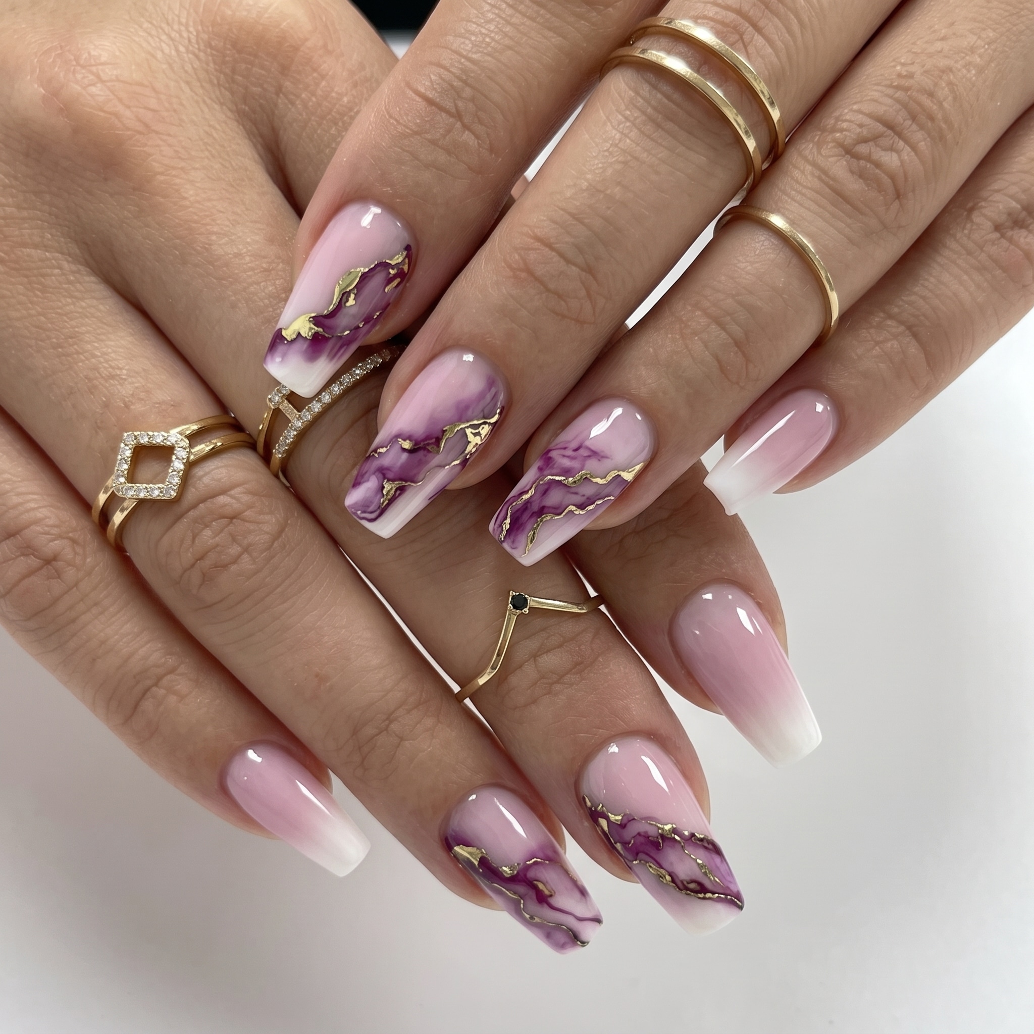 Red accent acrylic press-ons with heart details, glossy nude bases, and almond-shaped tips.