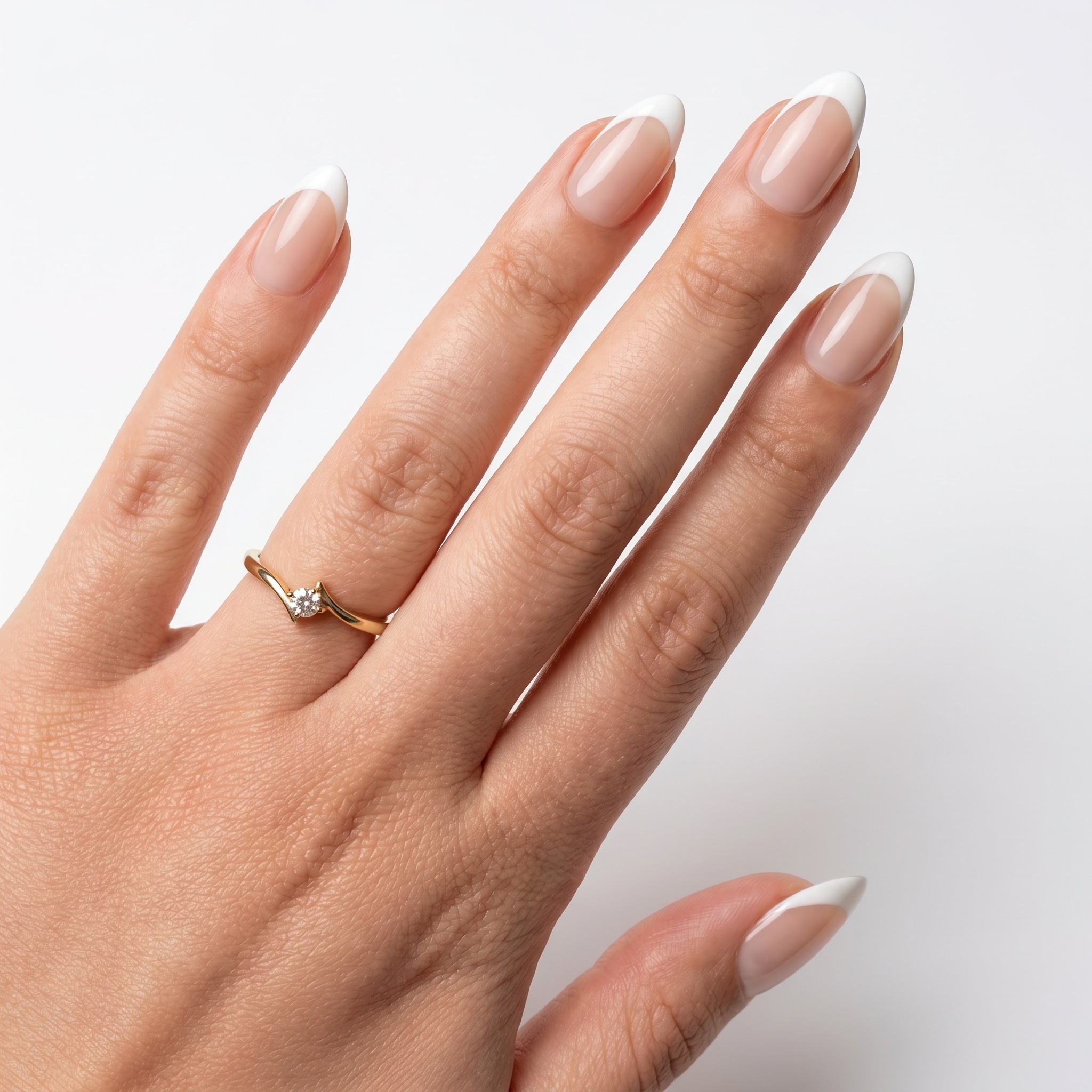 White French tips on nude almond nails against deep skin tones