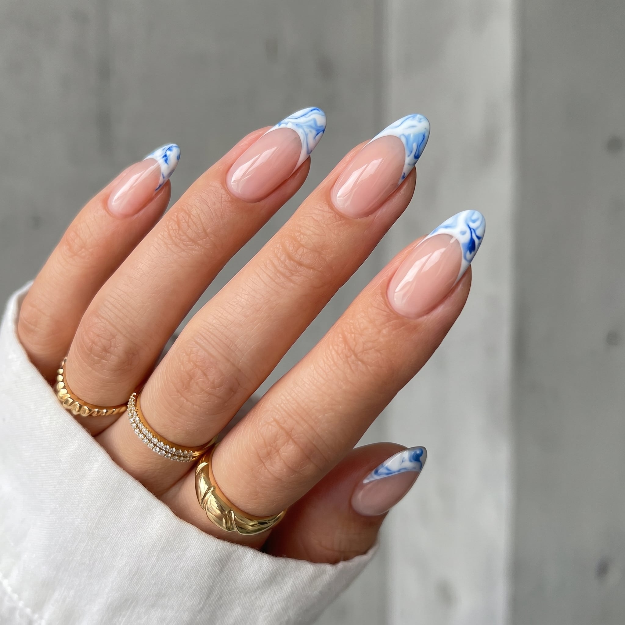 Short French nails with soft white tips and a glossy nude pink base