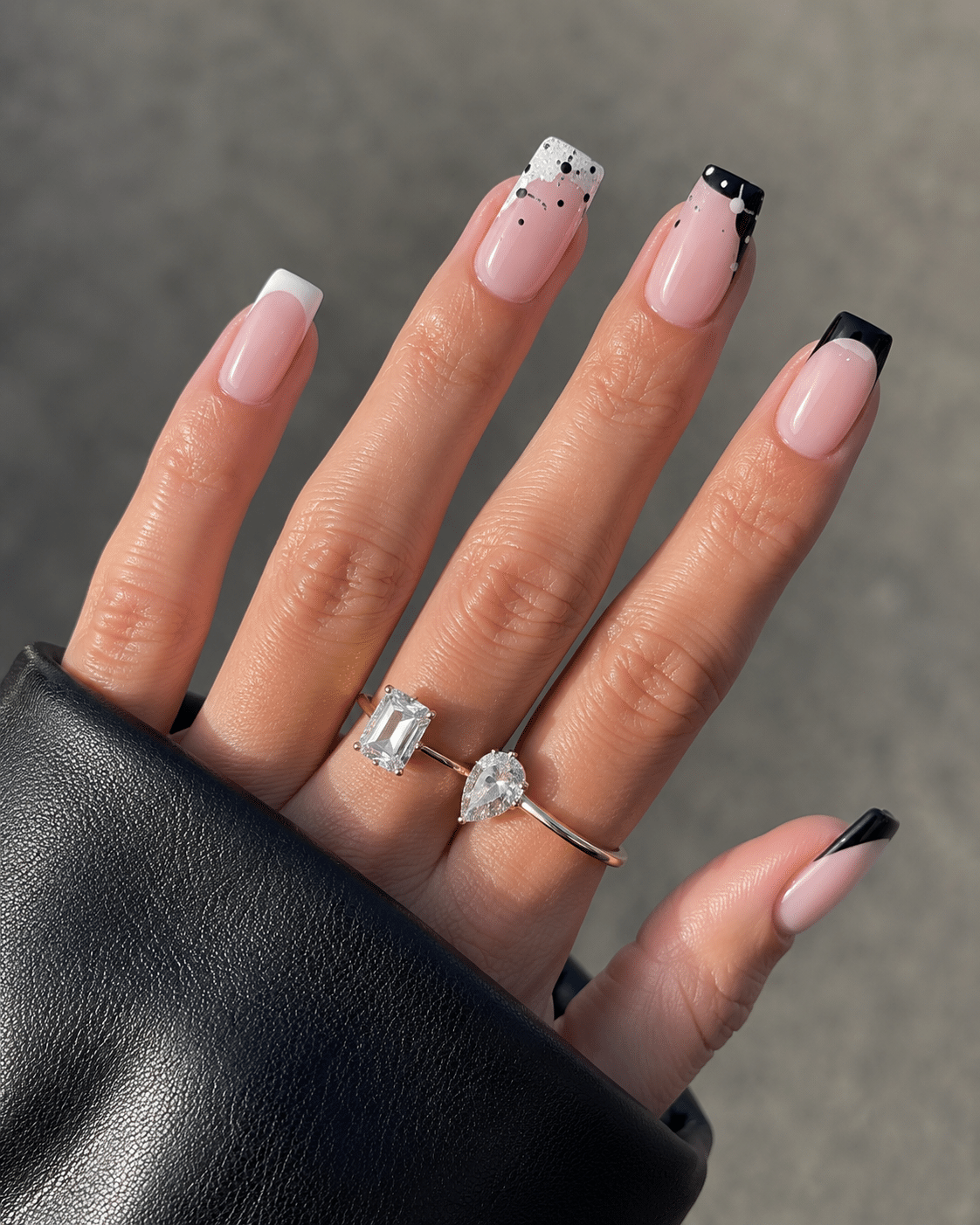 Glossy black French tip nails with a clean nude base