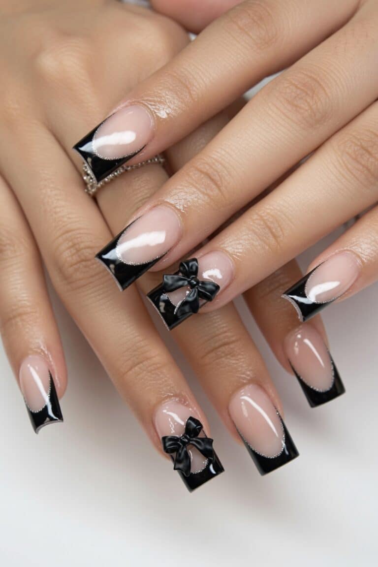 Classic black French tip press on nails on an elegant hand.