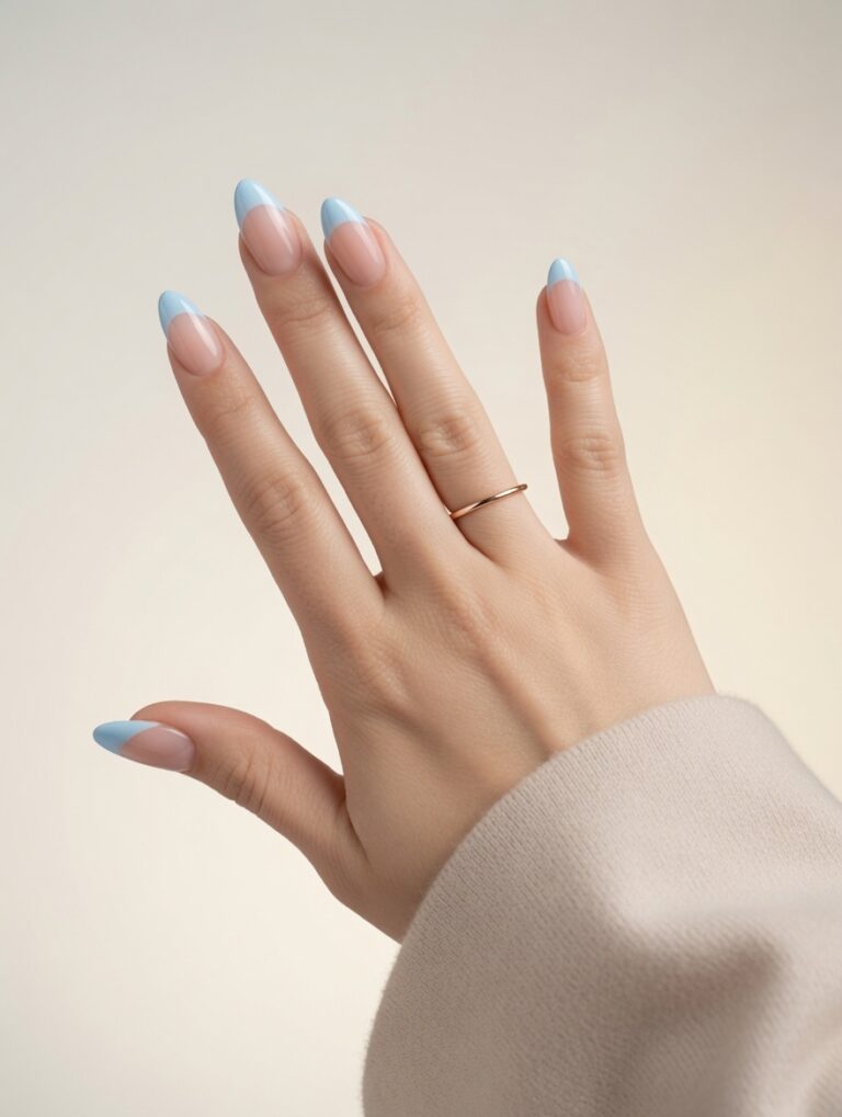 Blue almond French tip nails with a soft nude base and glossy light blue tips