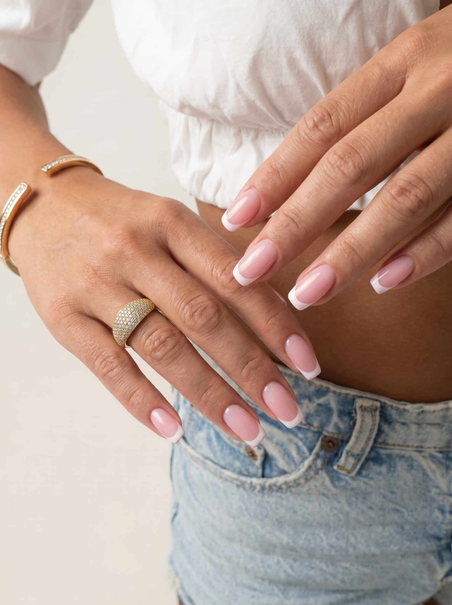 Colorful square French tip nails with bright summer accents and a nude glossy base