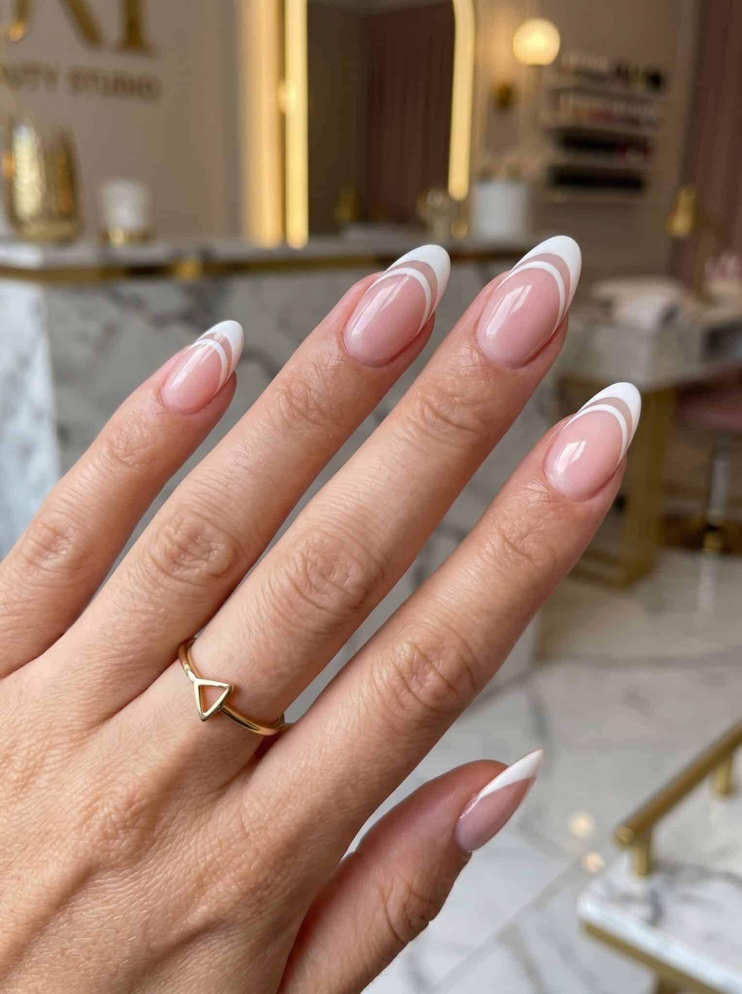 Short cute French tip nails with soft pastel color and a clean glossy finish