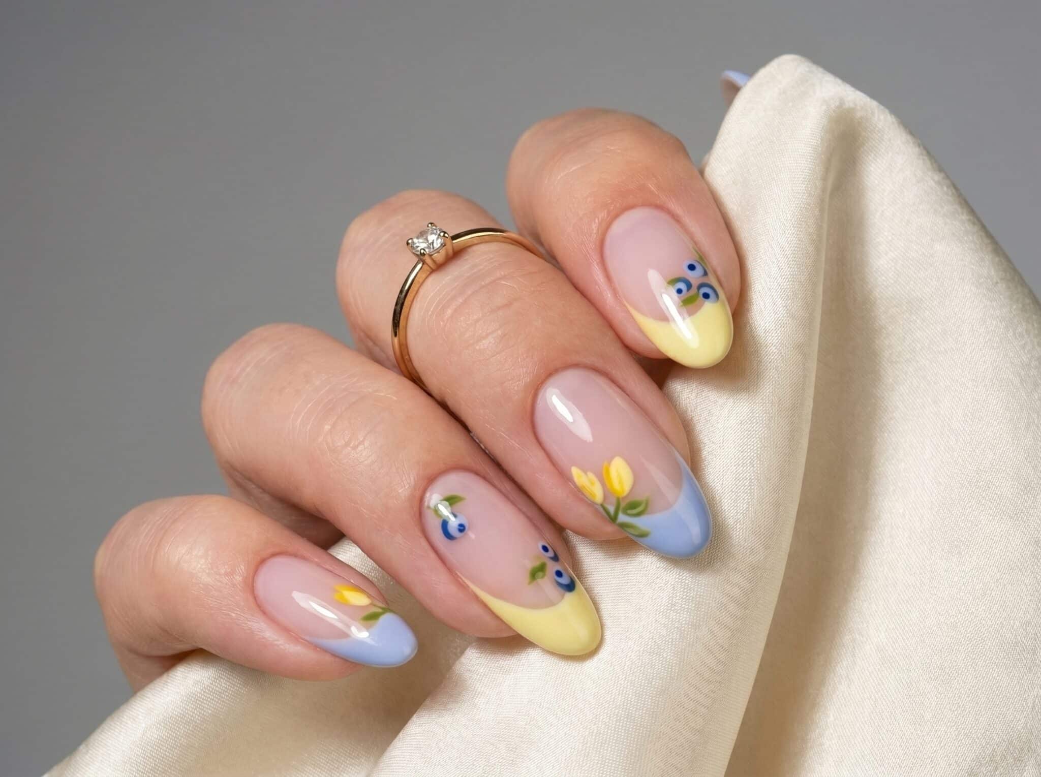 Blue summer French tip nails with a sheer nude base and glossy almond shape
