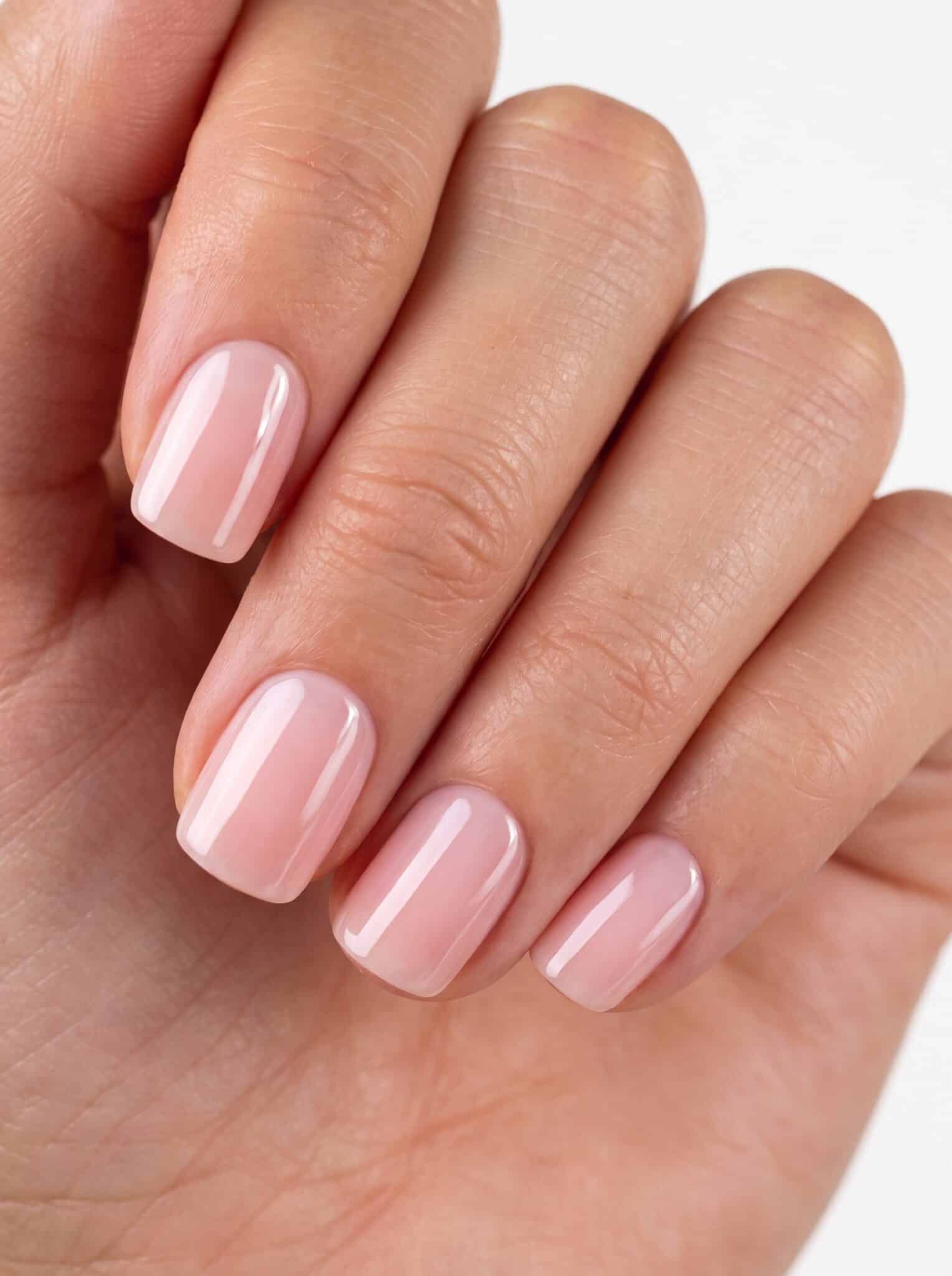 Collage of extra short nail looks showing nude, white, black, and soft everyday press-on styles.