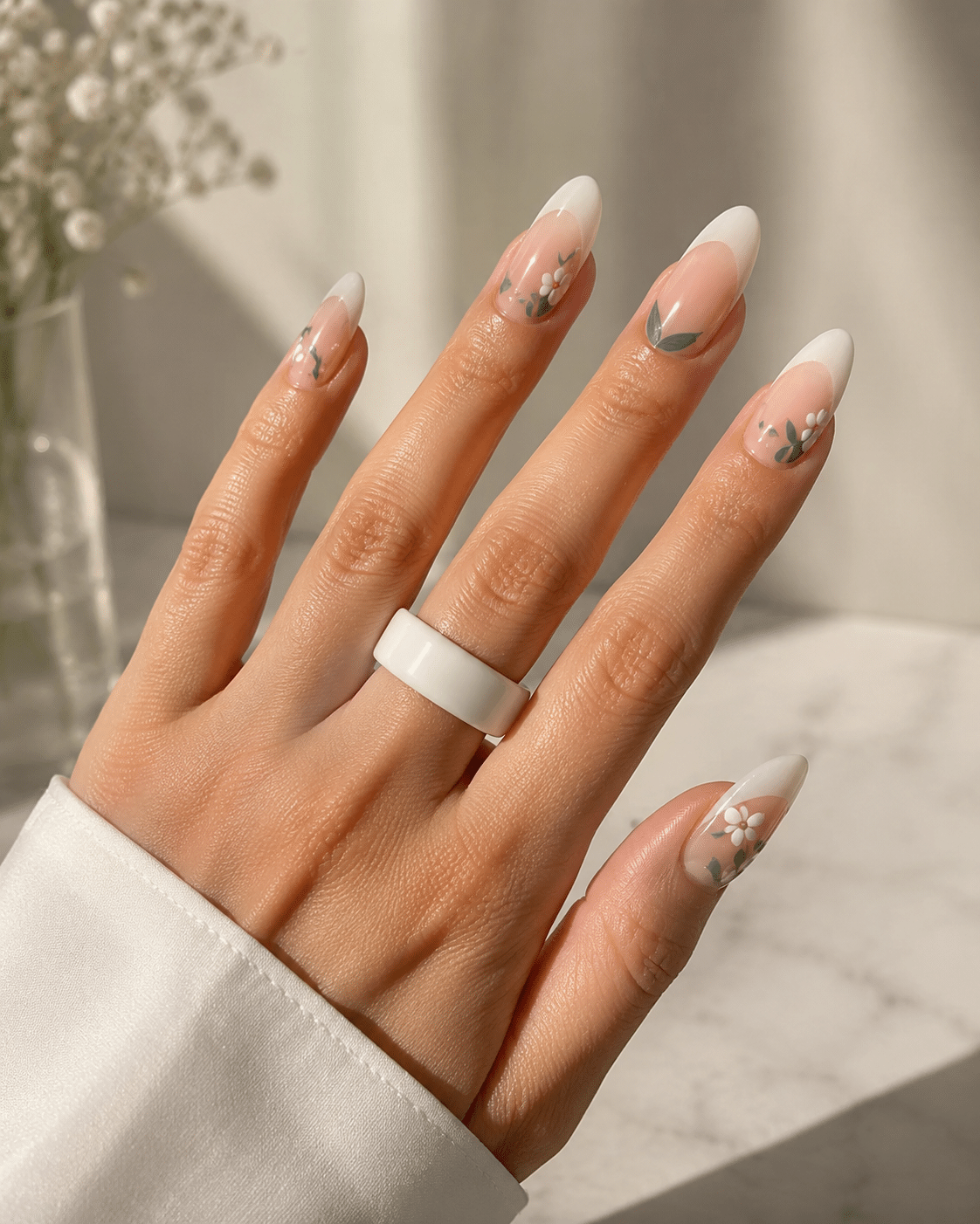 Floral French tip almond nails with tiny summer flower details