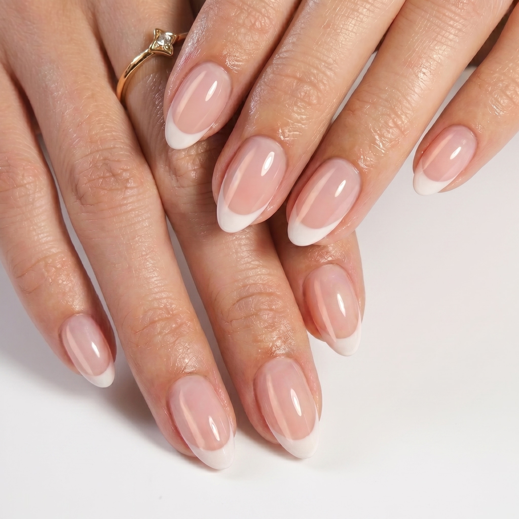 Long glossy nude nails with bright white French tips