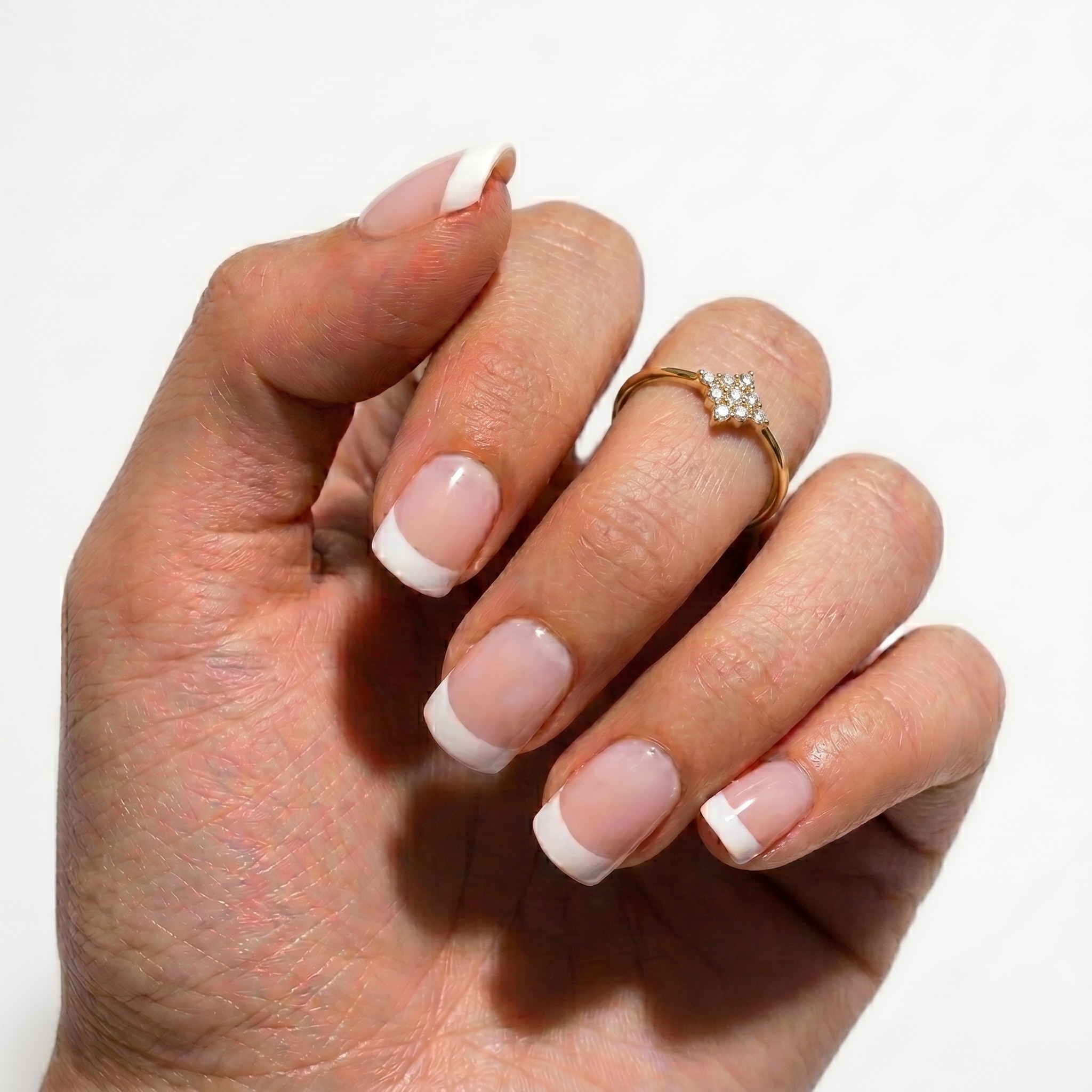Milky nude almond nails with soft white French tip details