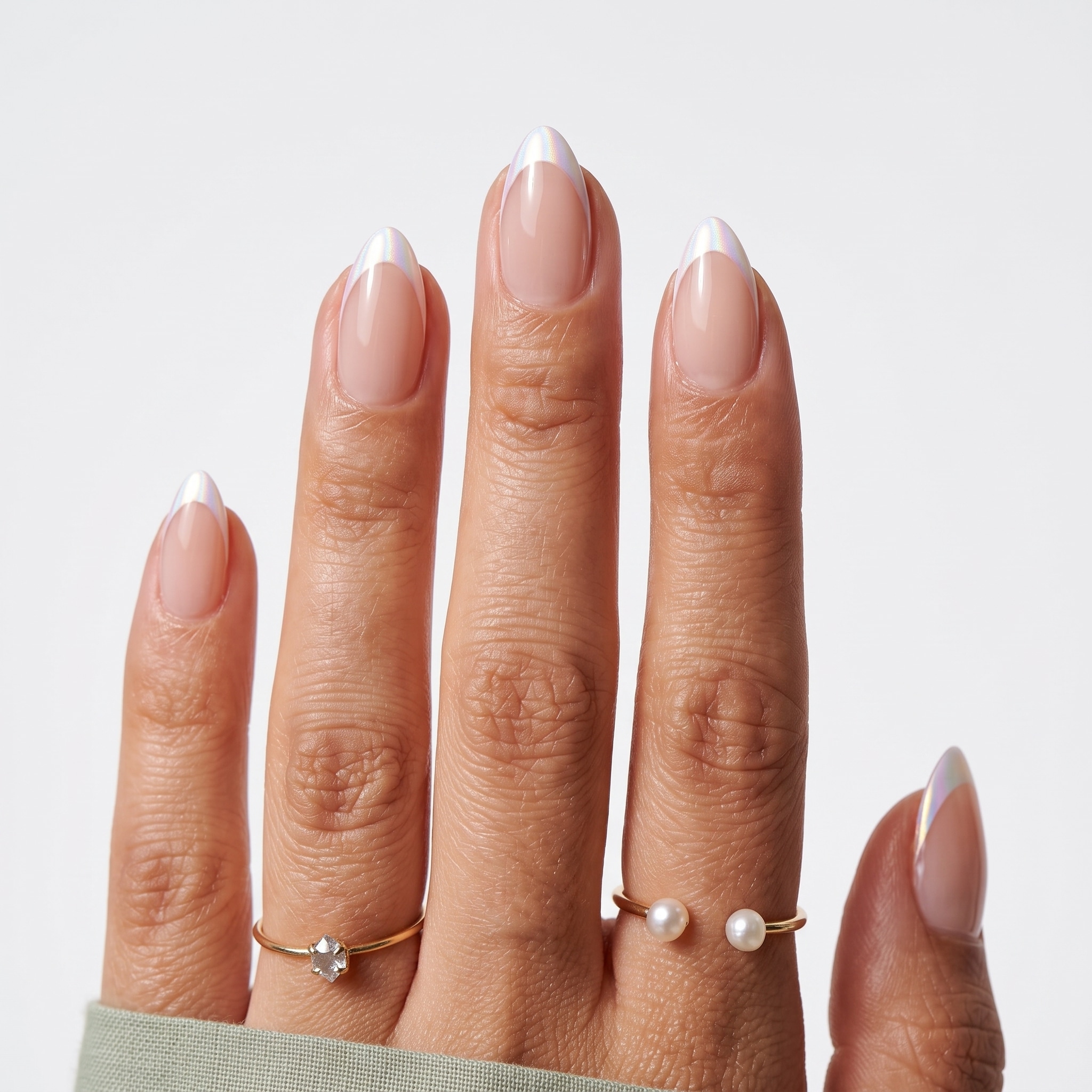 Minimal almond French press-ons with a sheer pink base and slim white tips on one hand.