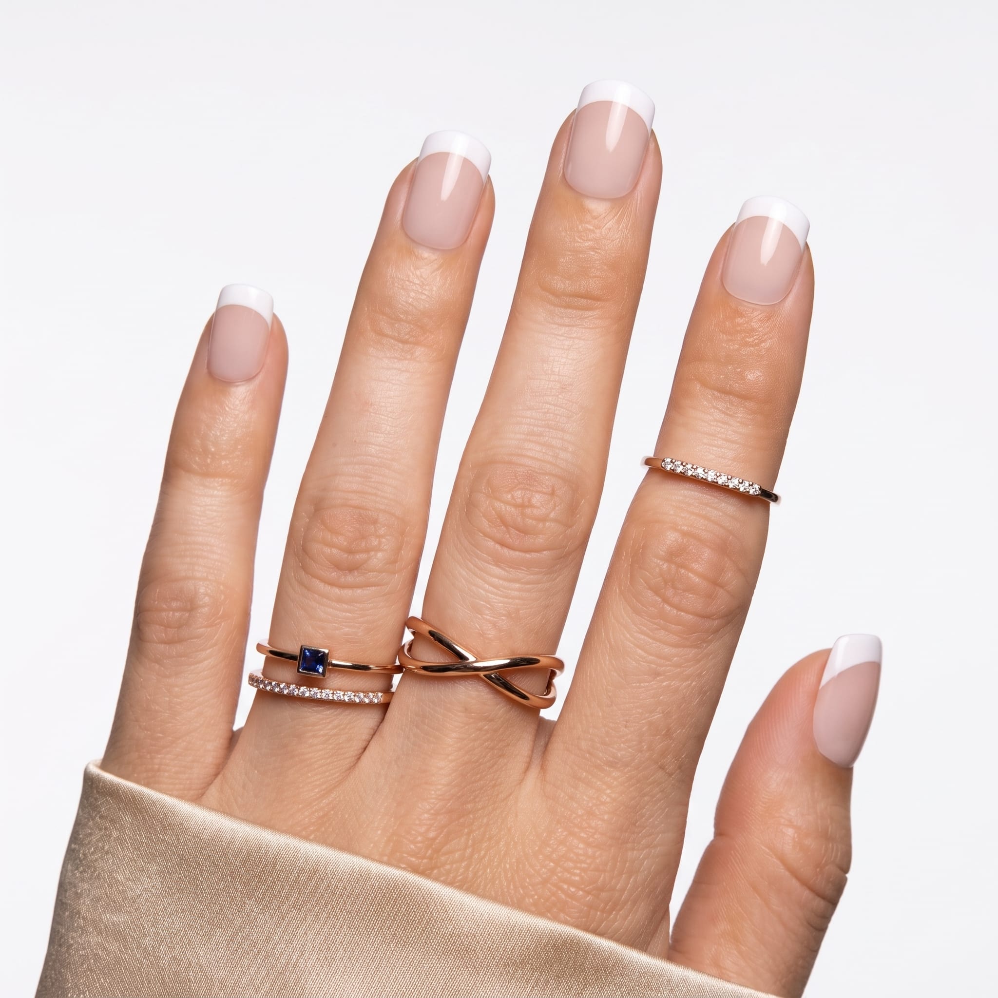 Clean classic French press-ons with rounded white tips and glossy nude-pink polish.