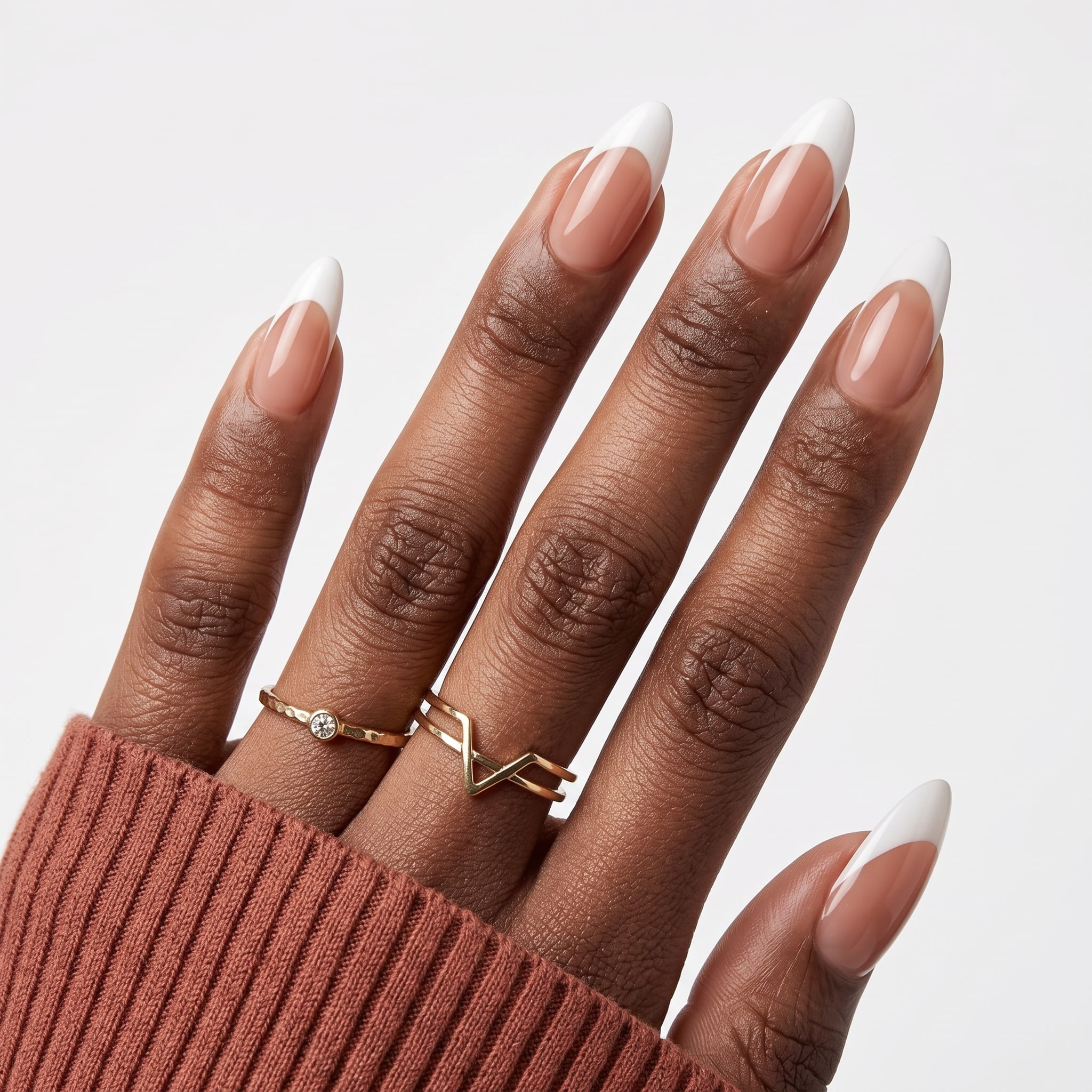 Elegant square French press-ons with crisp white tips, nude base, and delicate gold rings.