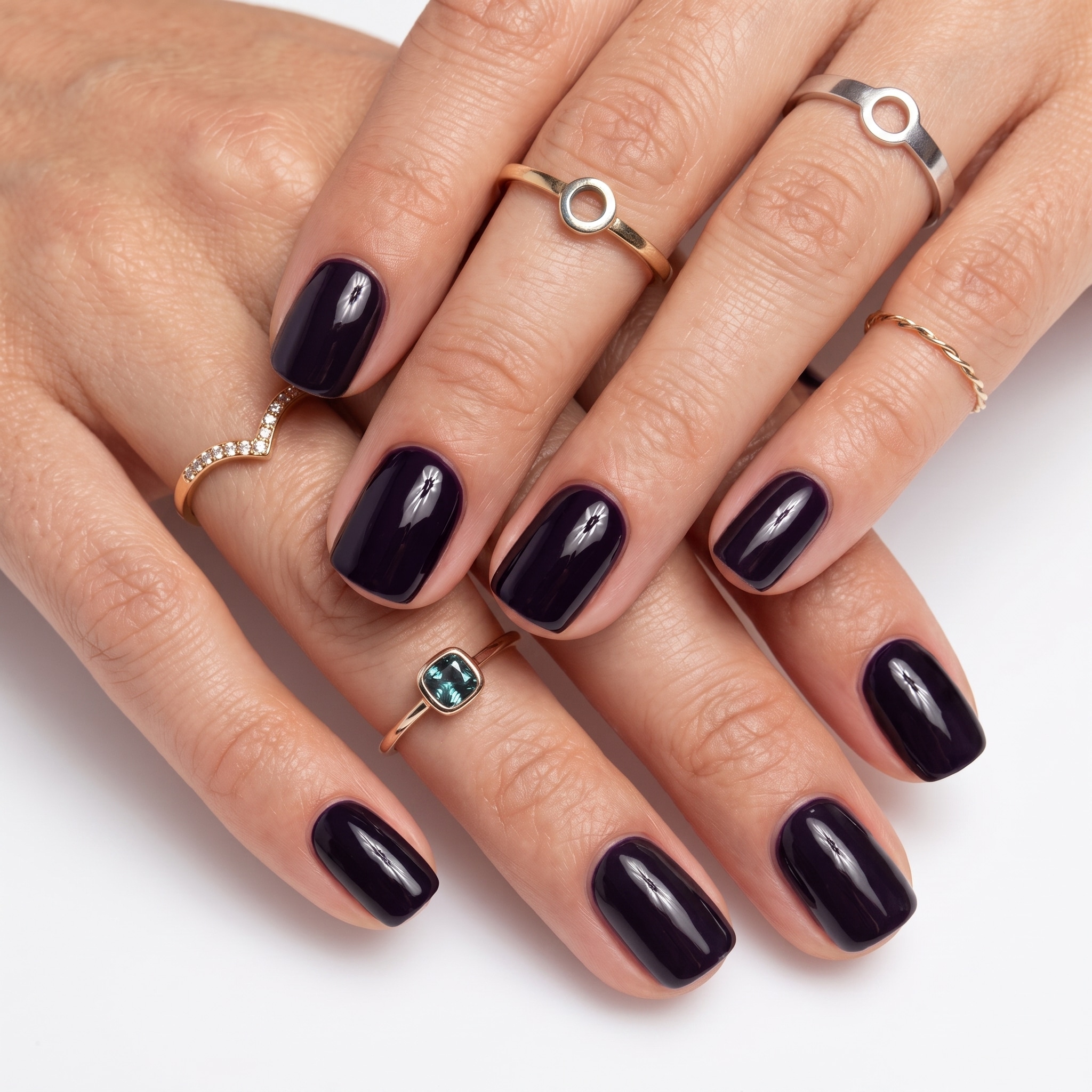Glossy navy short nails with a deep polished finish