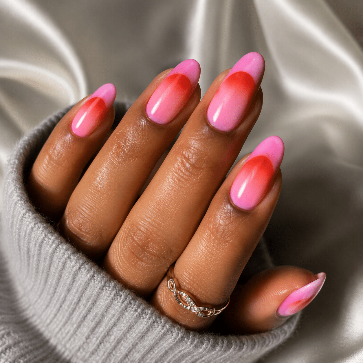 Almond nails with bright hot pink French tips and glossy finish