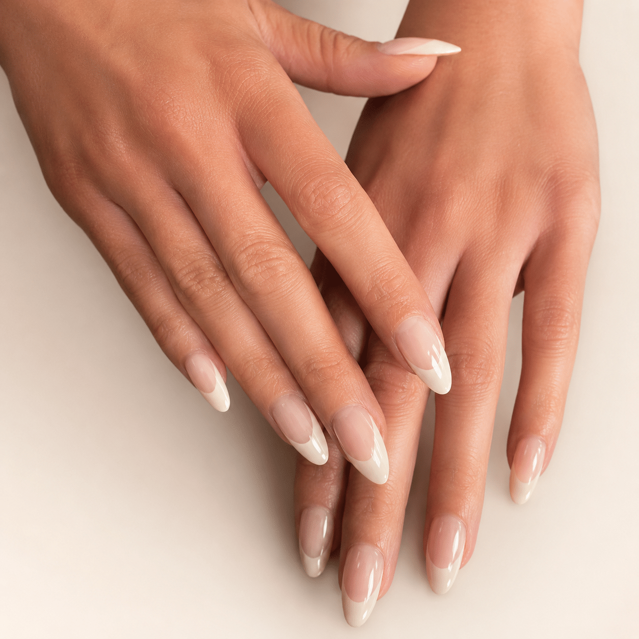 Milky white almond French tip nails with a soft nude base and precise white tips