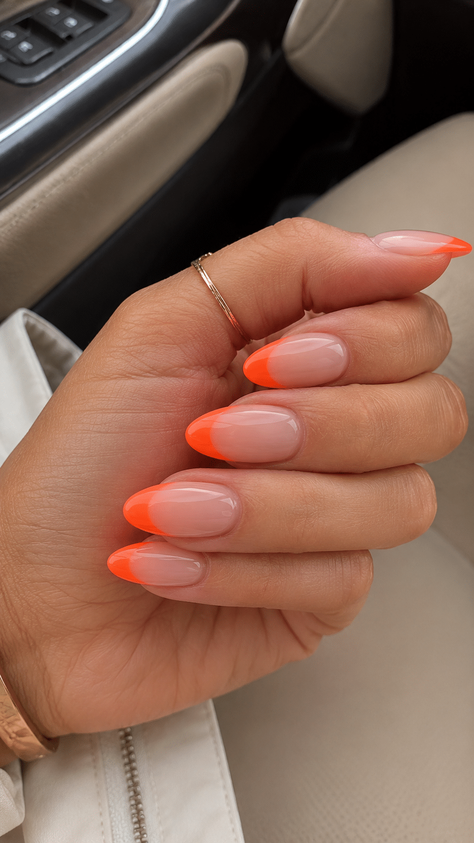 Orange almond French tip nails with a feminine lifestyle finish