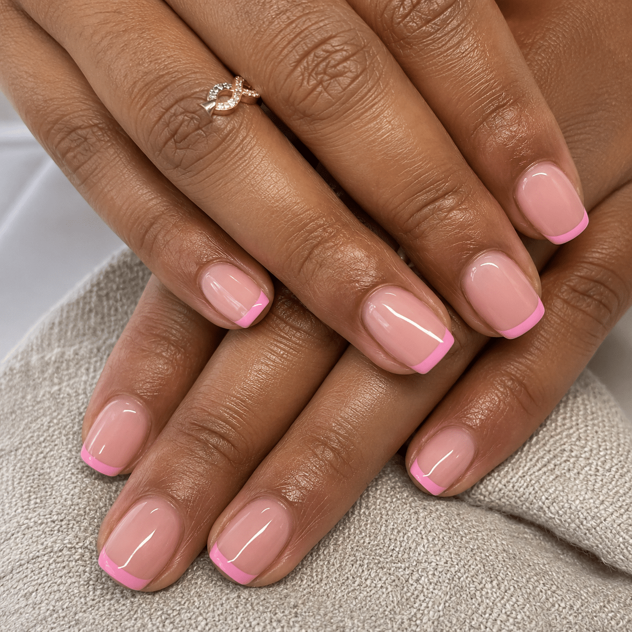 Short square nails with a sheer pink base and clean light pink tips
