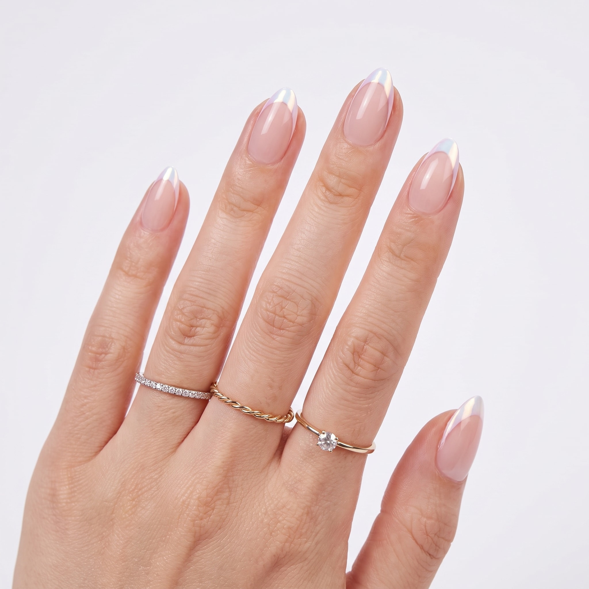 Short French tip press-ons with glossy pink bases, white tips, and delicate floral accent nail art.