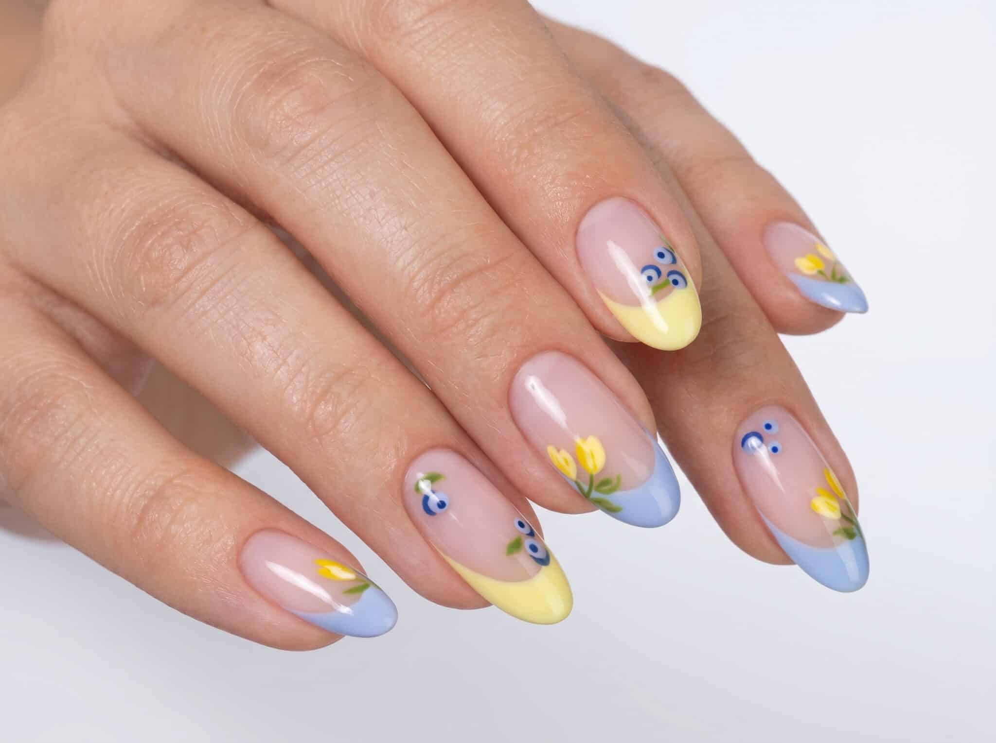 Simple blue French tip nails shown on both hands with a soft neutral background