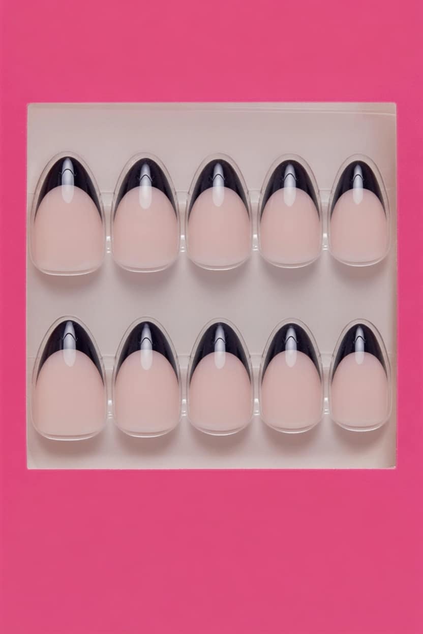 Short square black French tip nails with bow details.
