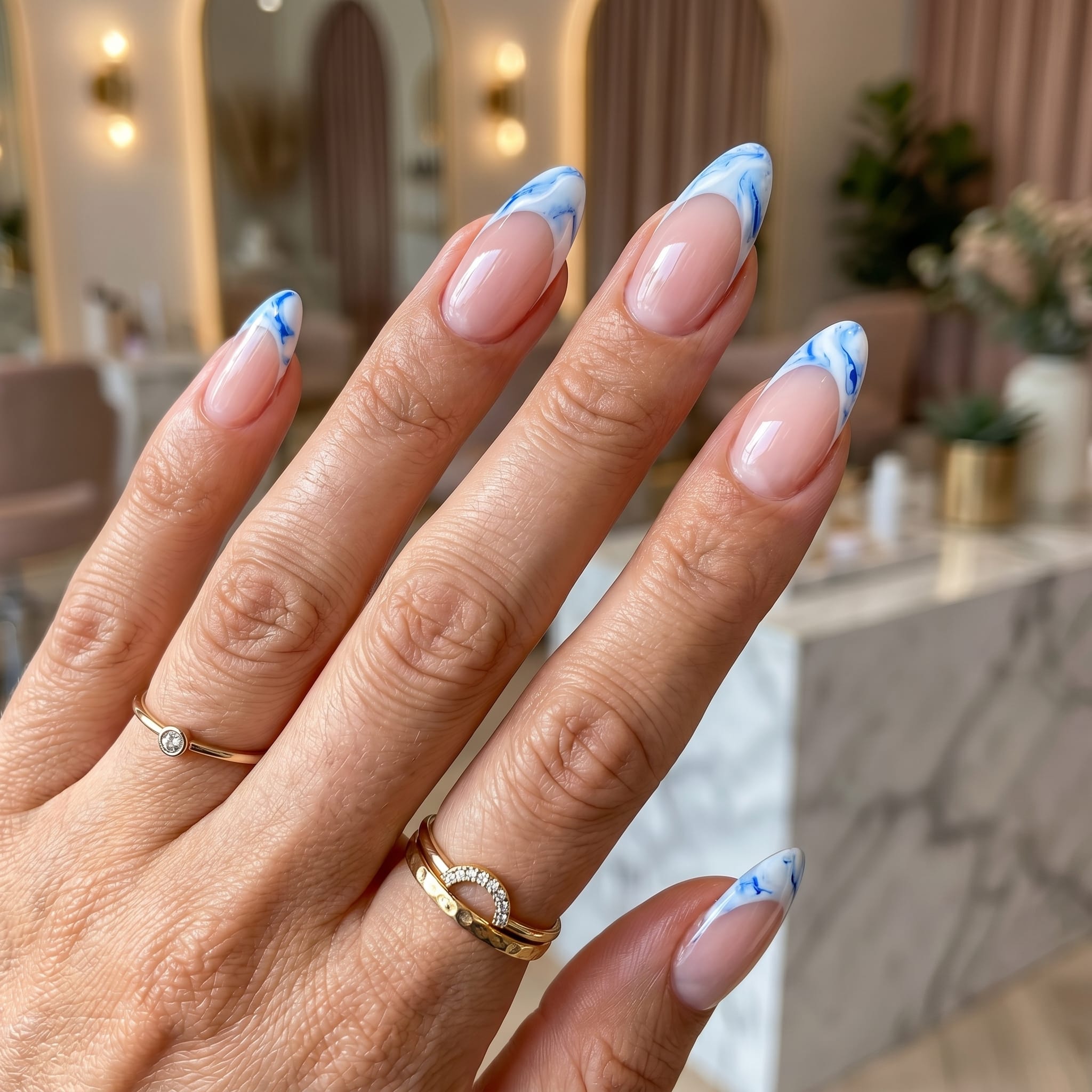 French tip nails with soft floral accent details and a glossy nude base