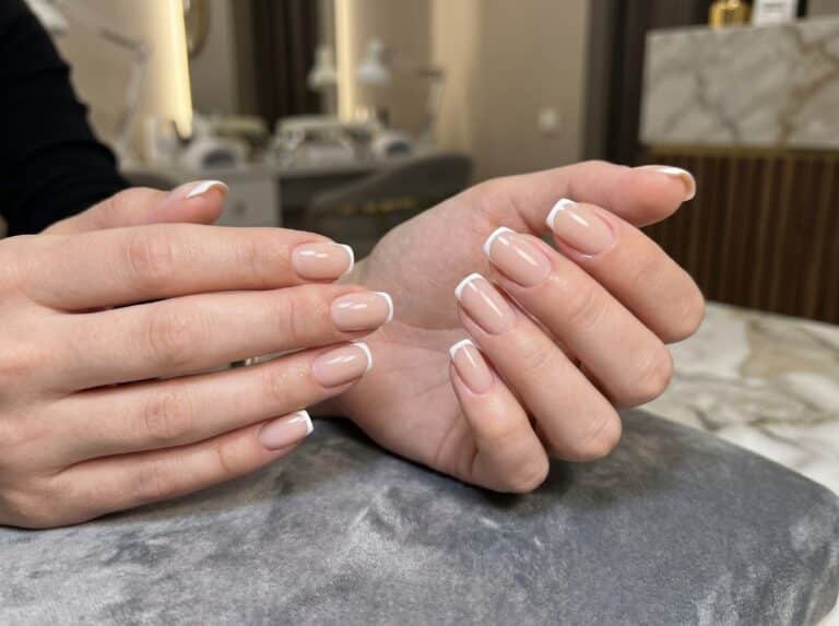 Hands showing short coffin French tips as a step-by-step manicure reference