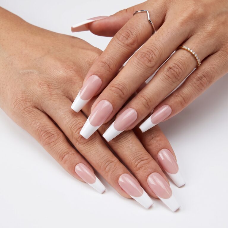 Minimal almond French press-ons with soft white tips and a natural glossy pink base on one hand.