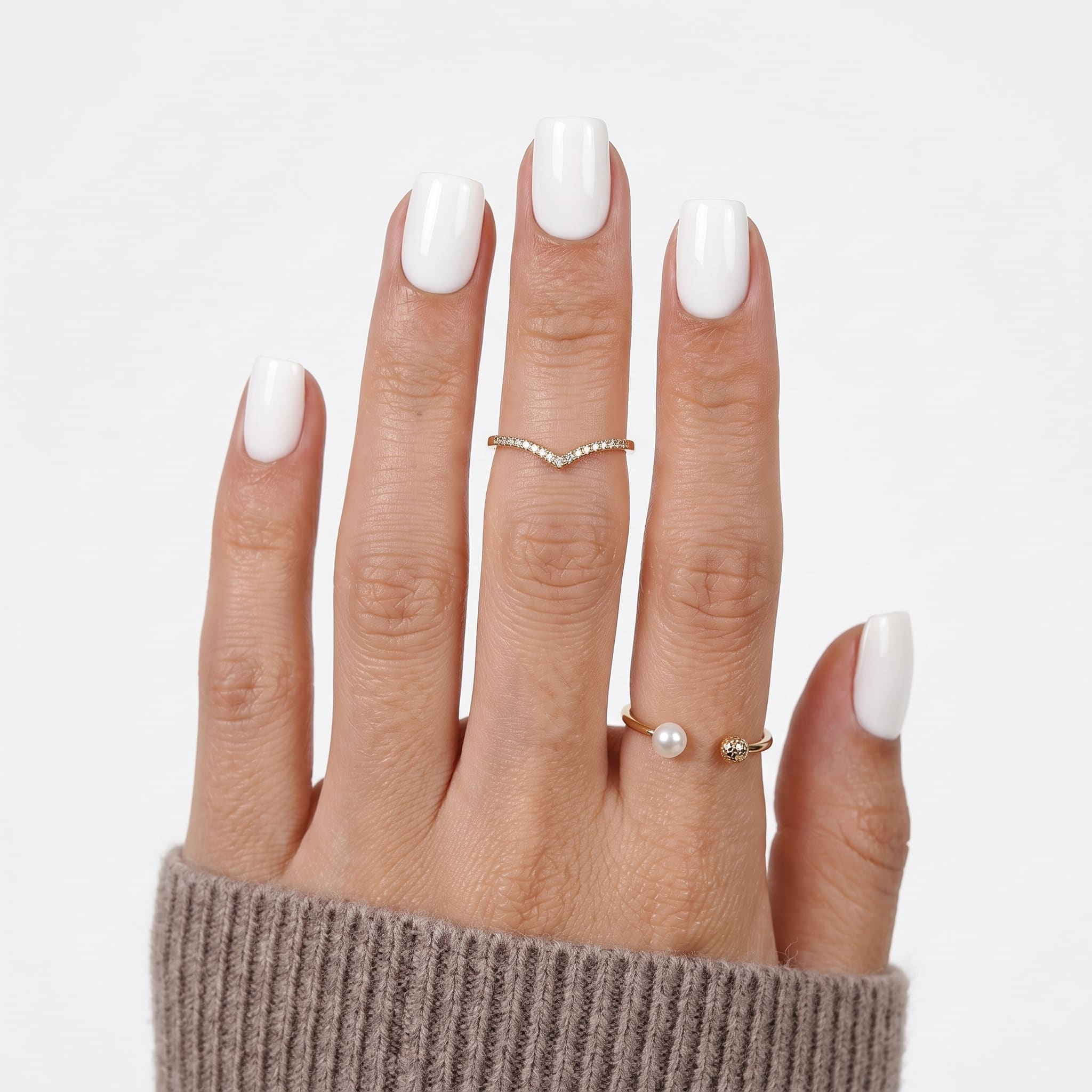White press on nails with glossy square tips, nude base, and soft beige sleeve styling.