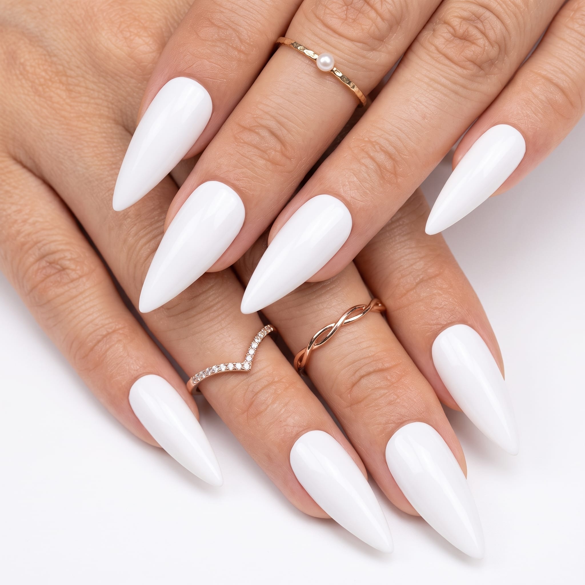 Glossy oval white press-ons with a soft milky finish and gold ring details.