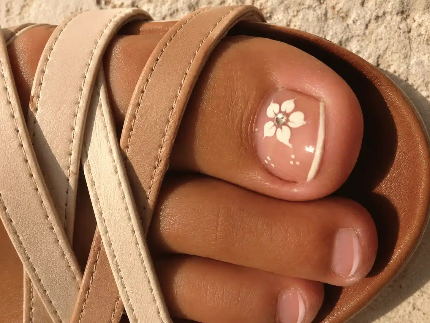 Floral French Pedicure: 8 Elegant Toe Nail Ideas 2 French pedicure with a white daisy accent