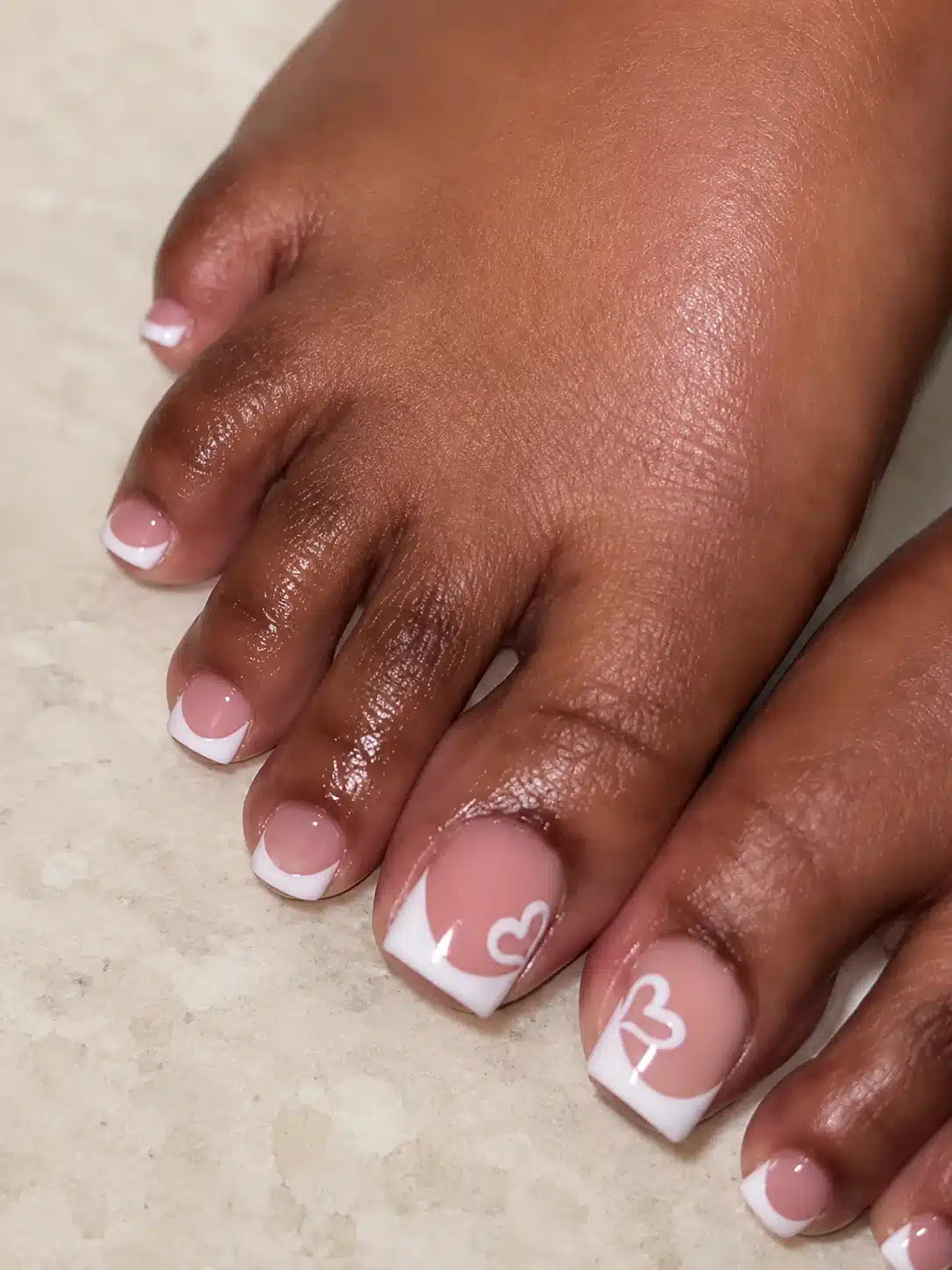 French Pedicure With Heart: 6 Romantic Toe Ideas 3 Pink French toes with heart details on deep skin