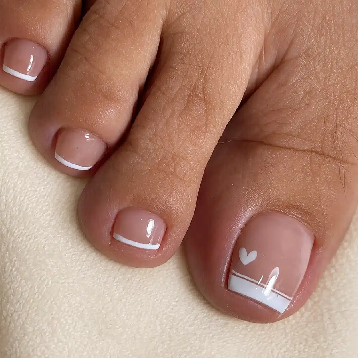 French Pedicure With Heart: 6 Romantic Toe Ideas 6 Minimalist white French toes with a heart detail
