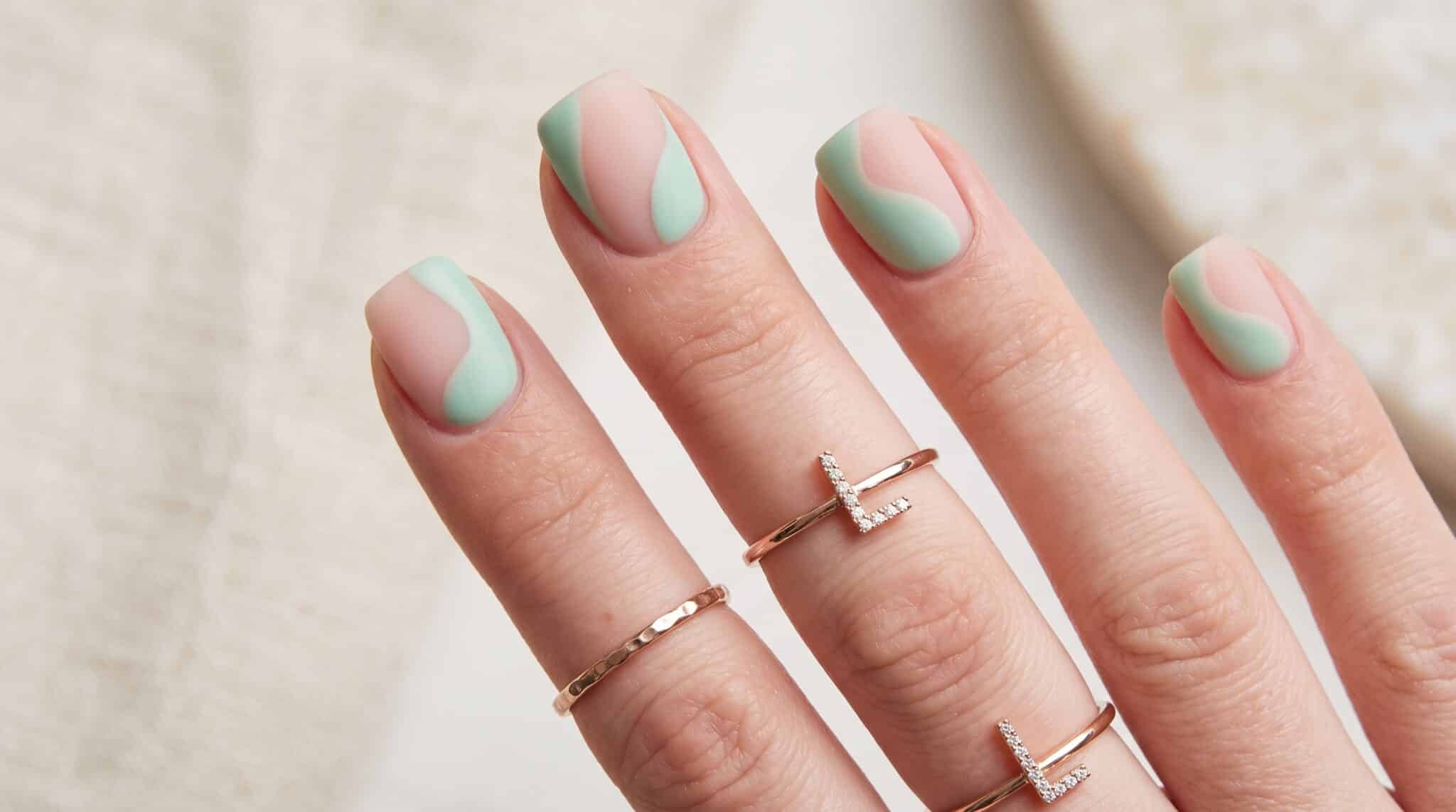 Applying press-on nails close up during an at-home nail routine