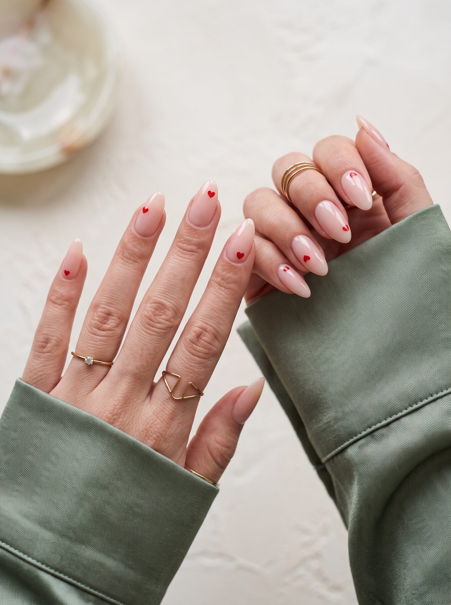Glossy pink press-on nails with a clean almond shape