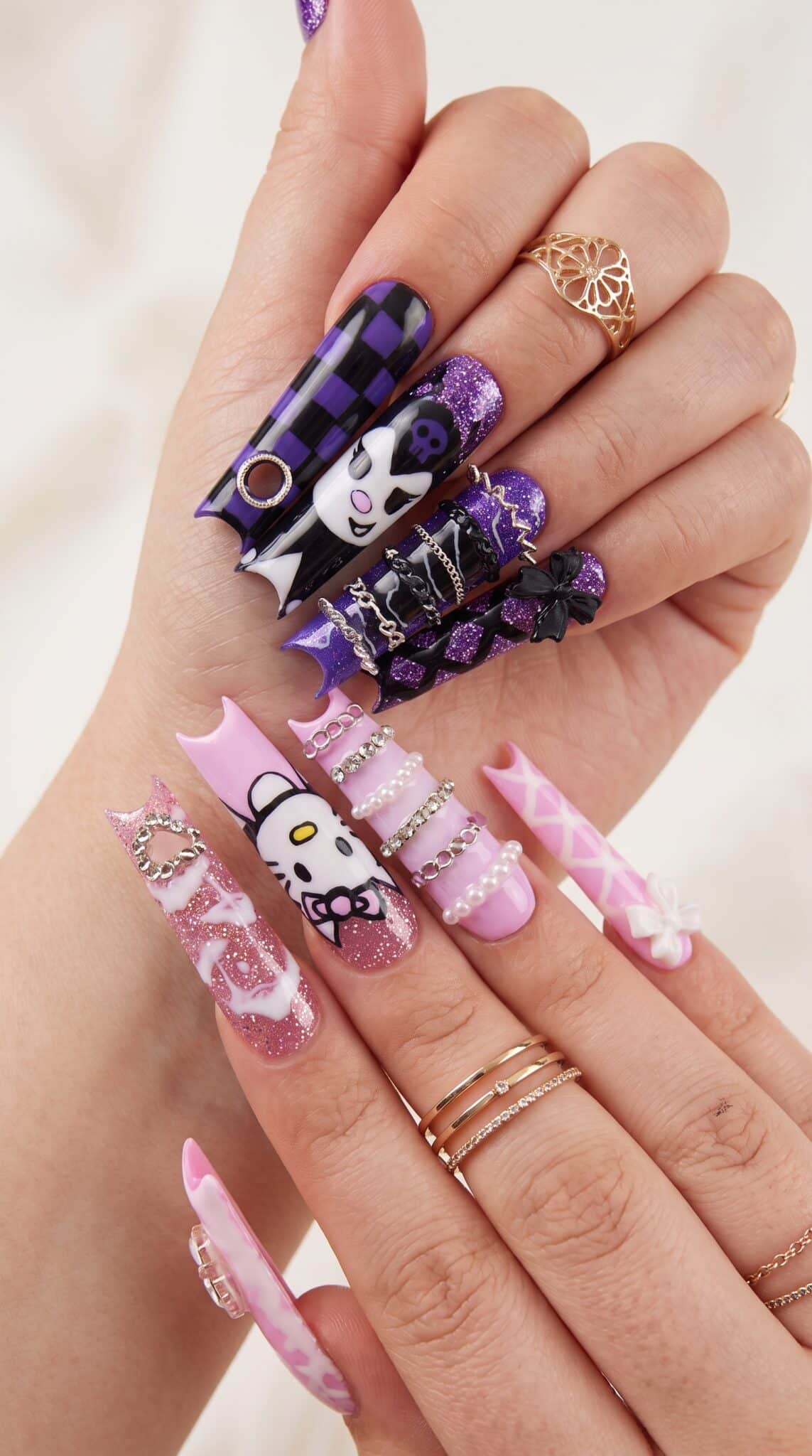 Heart press-on nails with a soft pink base and playful black accent details