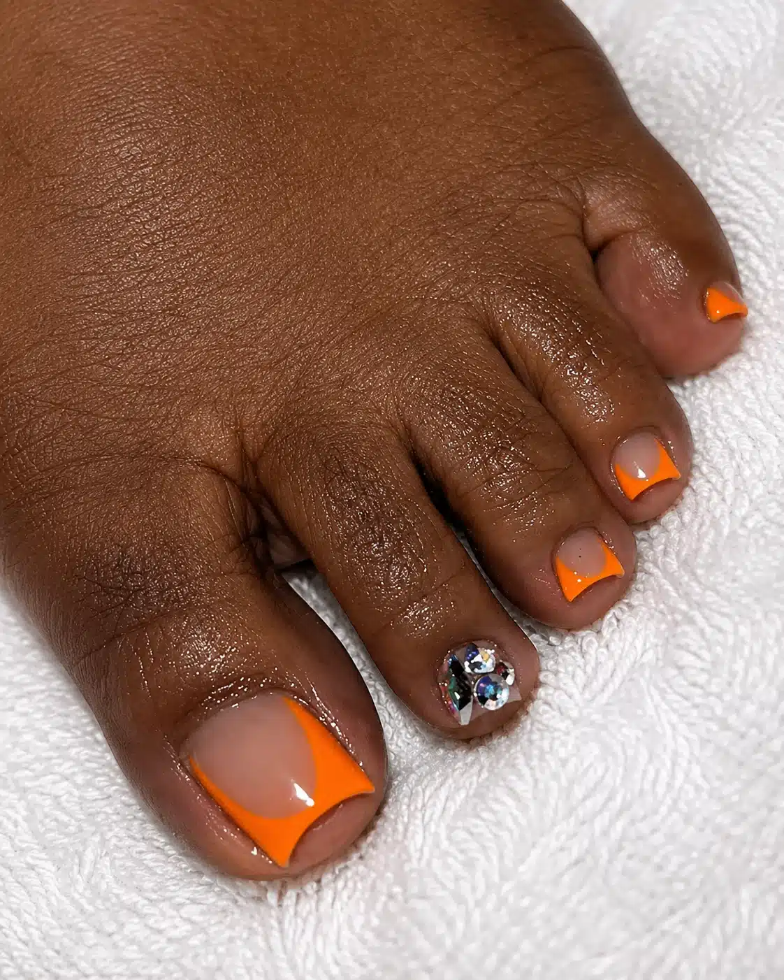 Orange French Tip Toes: Bright Color French Pedicure Ideas 2 Orange French tip pedicure on deep skin tone