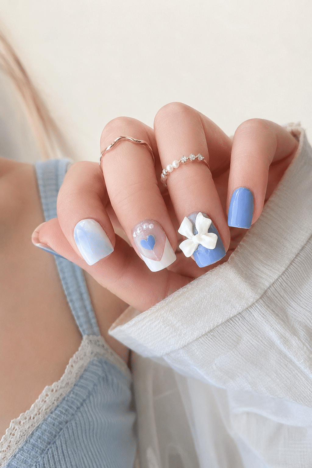 Baby blue bow French tip press on nails with a soft glossy finish