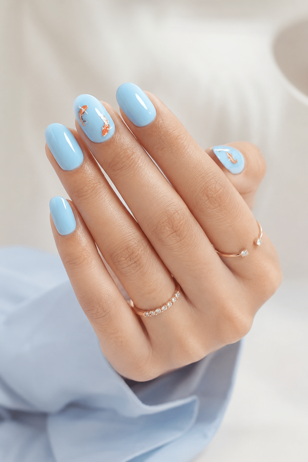 Blue flower short oval press ons with glossy pastel manicure design