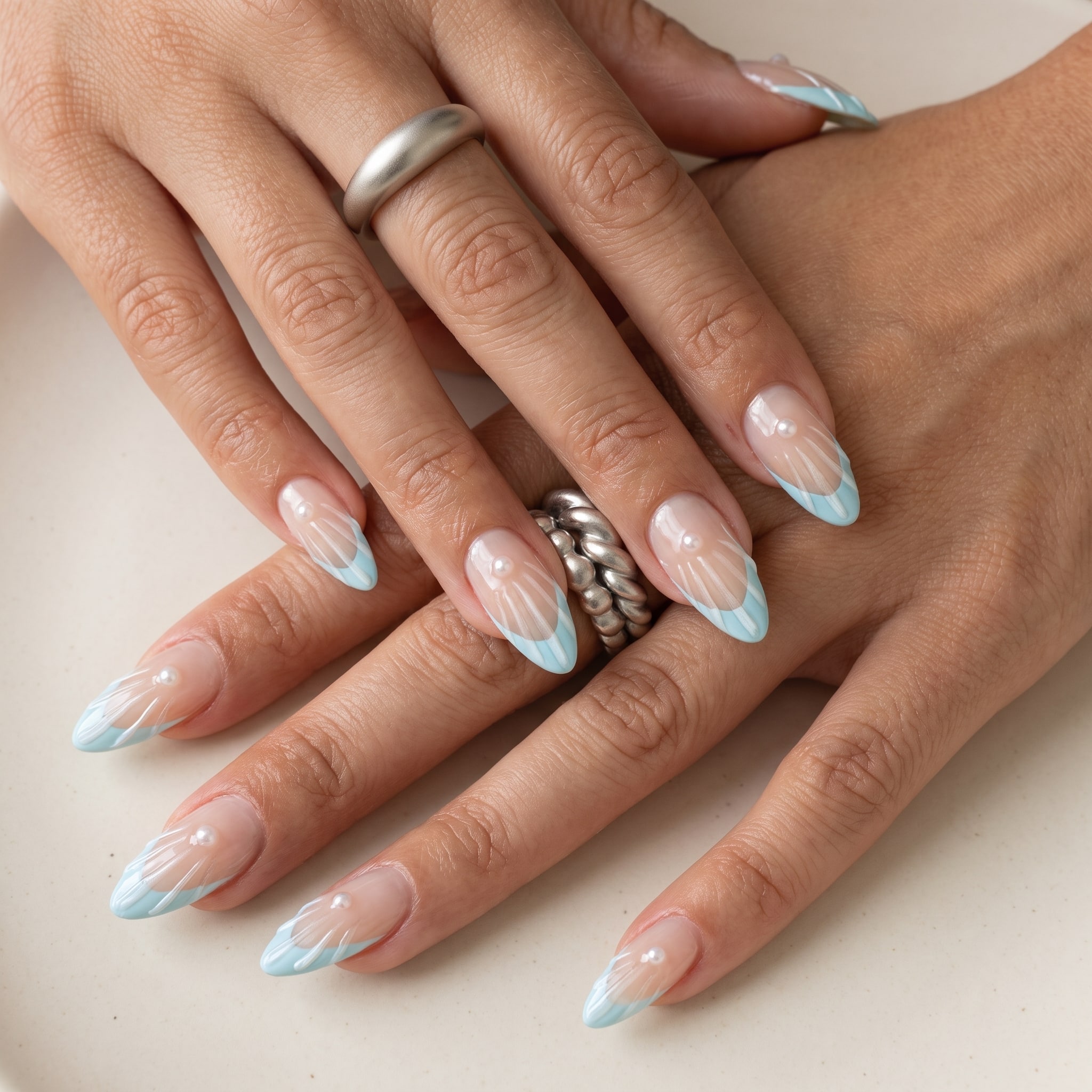 orange logomania french tip nails with glossy nude base and gold details
