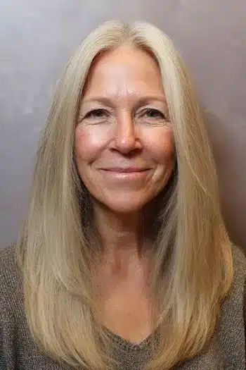 A center-parted layered look for fine hair, featured in 30 inspiring long hairstyles for women over 50 with fine hair.