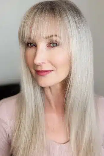 Airy wispy bangs on long fine hair, part of 30 inspiring long hairstyles for women over 50 with fine hair.