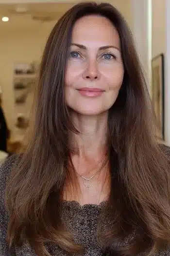 Medium-length layers integrated into long hair, part of 30 inspiring long hairstyles for women over 50 with fine hair.