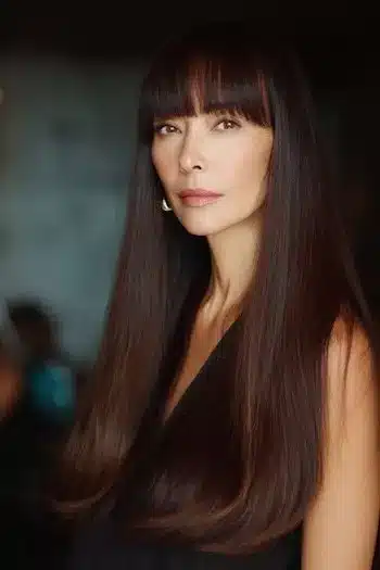 Sharp blunt bangs paired with long hair, part of 30 inspiring long hairstyles for women over 50 with fine hair.