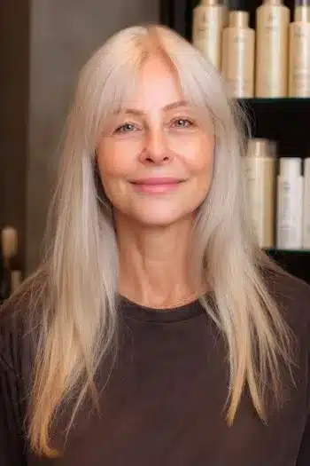 Wispy curtain bangs on fine hair, part of 30 inspiring long hairstyles for women over 50 with fine hair.